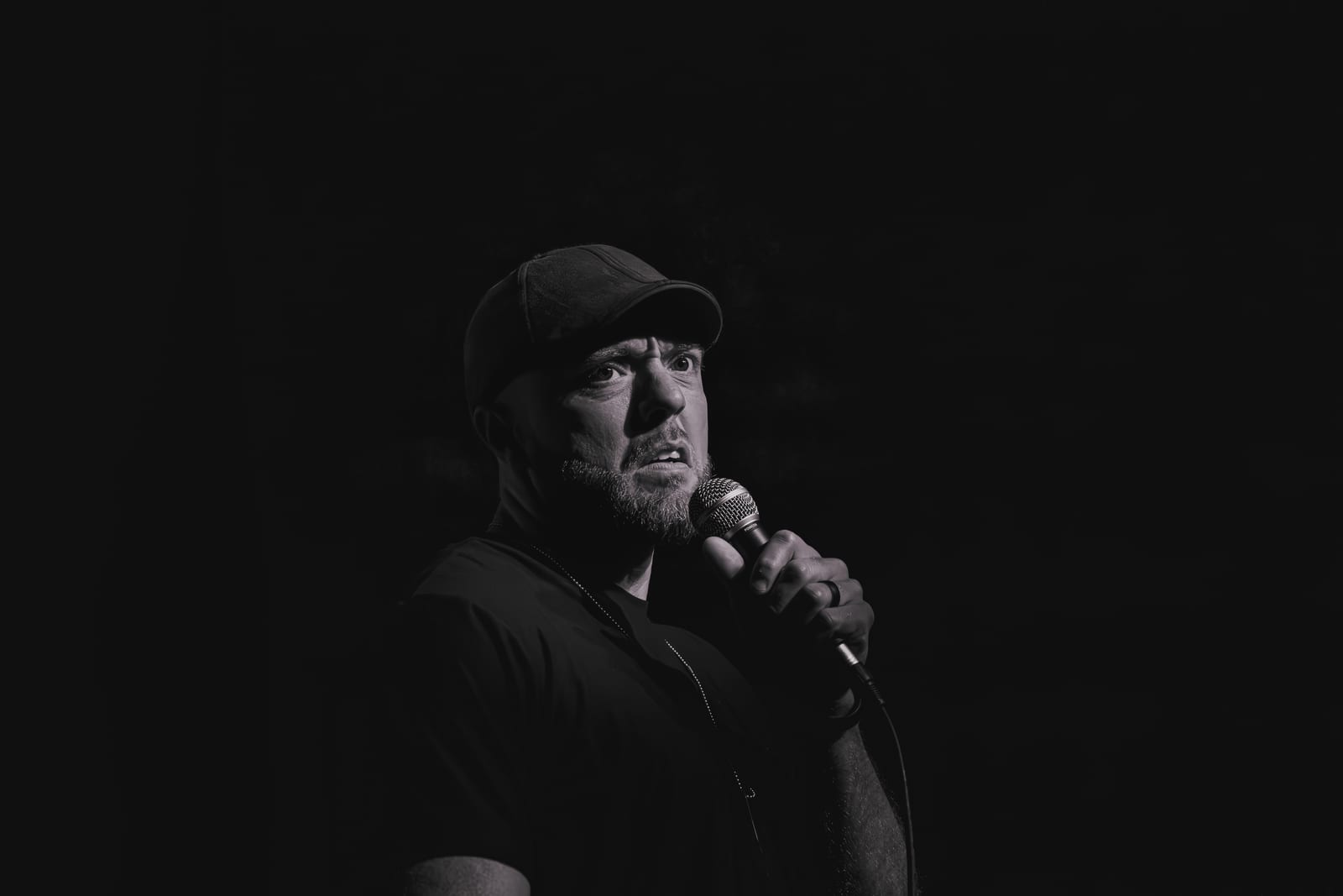 Stand-up comedian performing under a spotlight